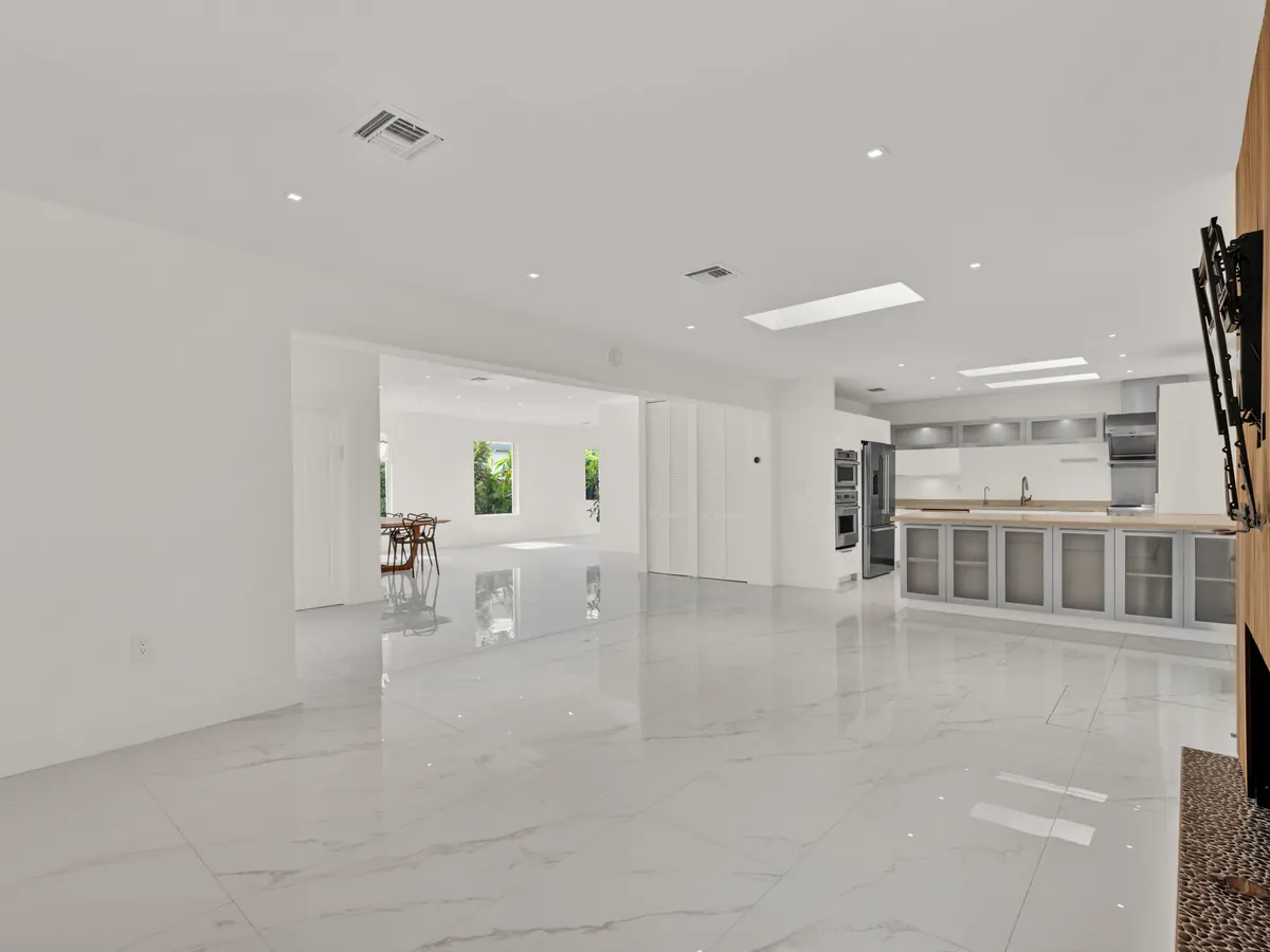 Renovated chef's kitchen with stainless steel appliances and large island