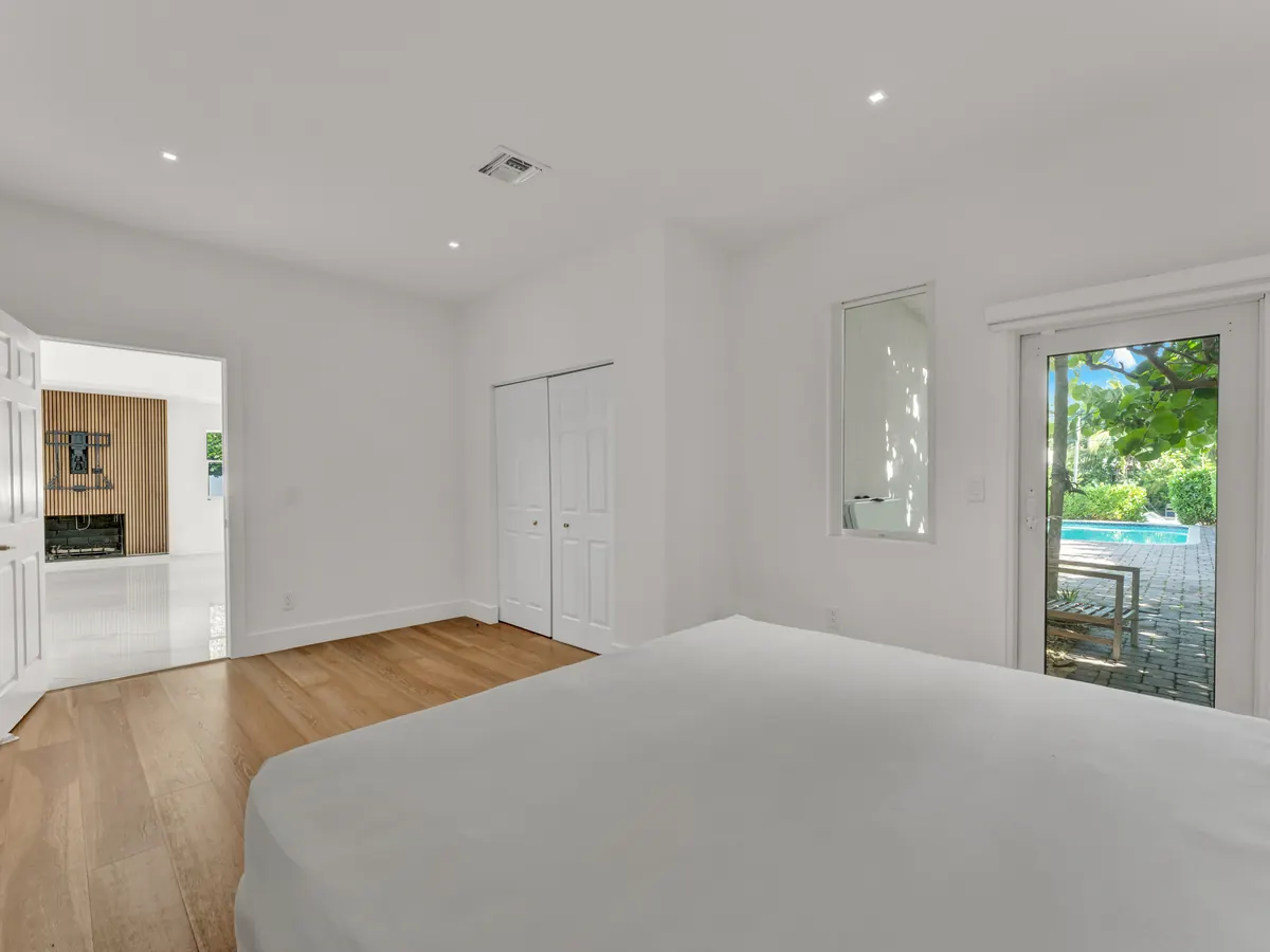 Bright bedroom with warm wood flooring